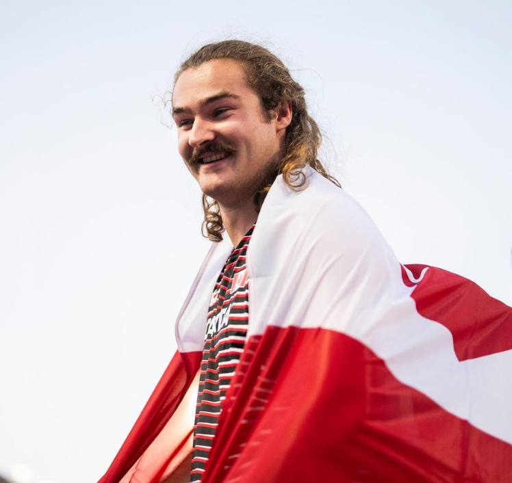 Nanaimo gold medalist carrying Canadian flag in Olympic closing ceremonies